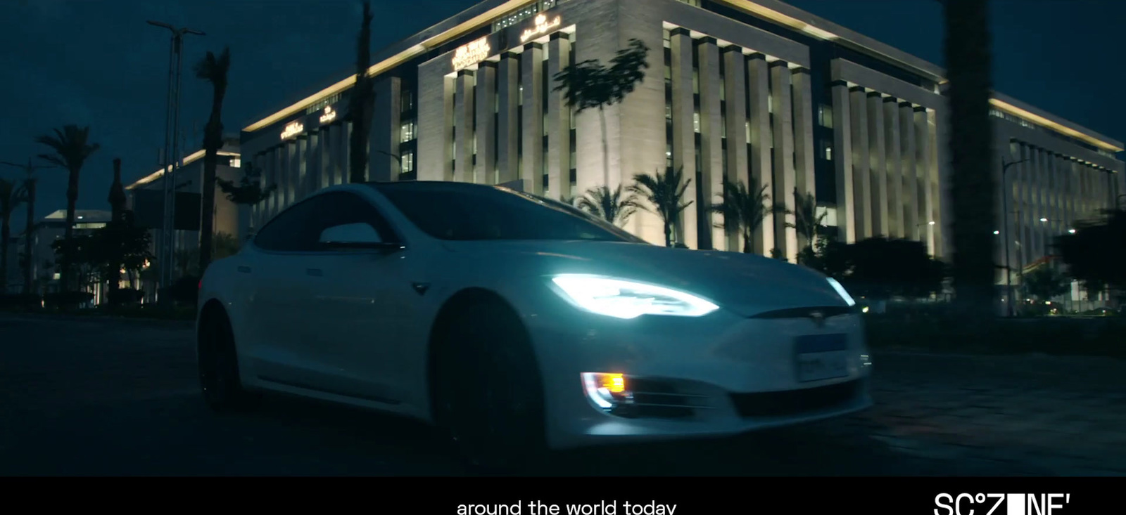 a white car parked in front of a building