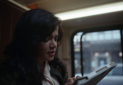 a woman looking at a piece of paper on a train