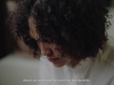 a close up of a person with curly hair