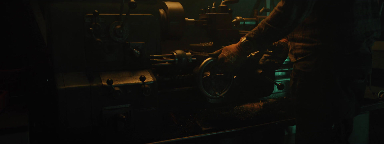 a man working on a machine in a dark room