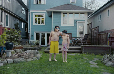 a couple of people standing in front of a house
