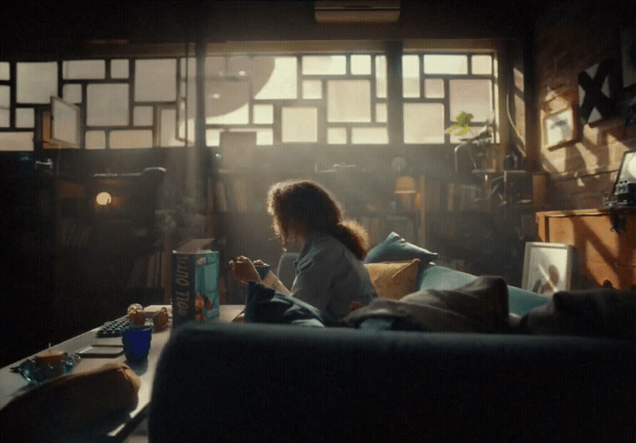 a woman sitting on a couch reading a book