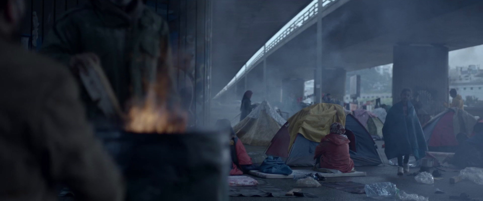 a group of people standing around a fire