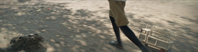 a man riding a scooter down a dirt road