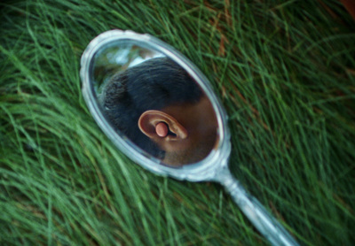 a man's head is seen through a magnifying glass