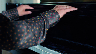 a person playing a piano in a room