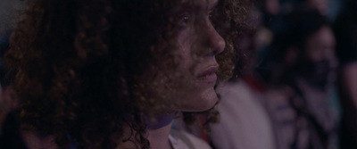 a close up of a person with curly hair