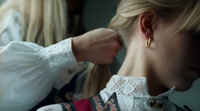 a woman getting her hair styled by another woman