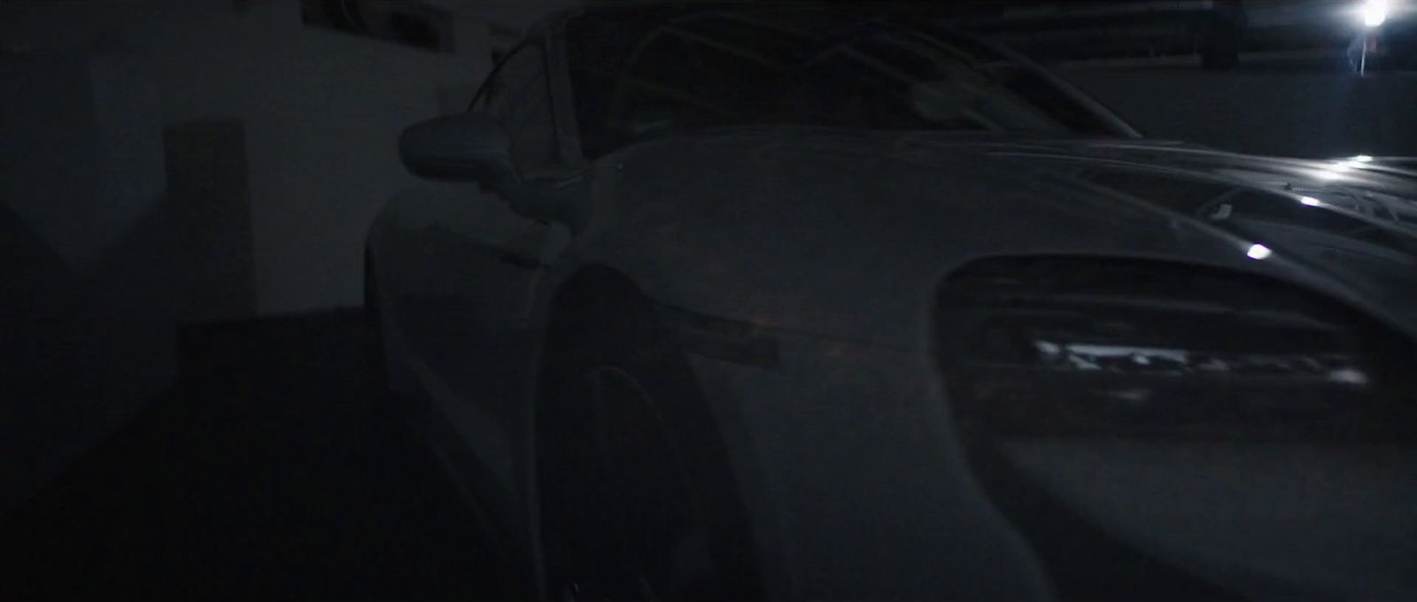 a car parked in a garage at night