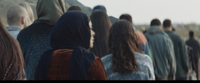 a group of people walking down a street