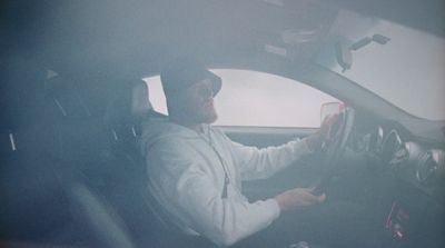 a man driving a car in a foggy day