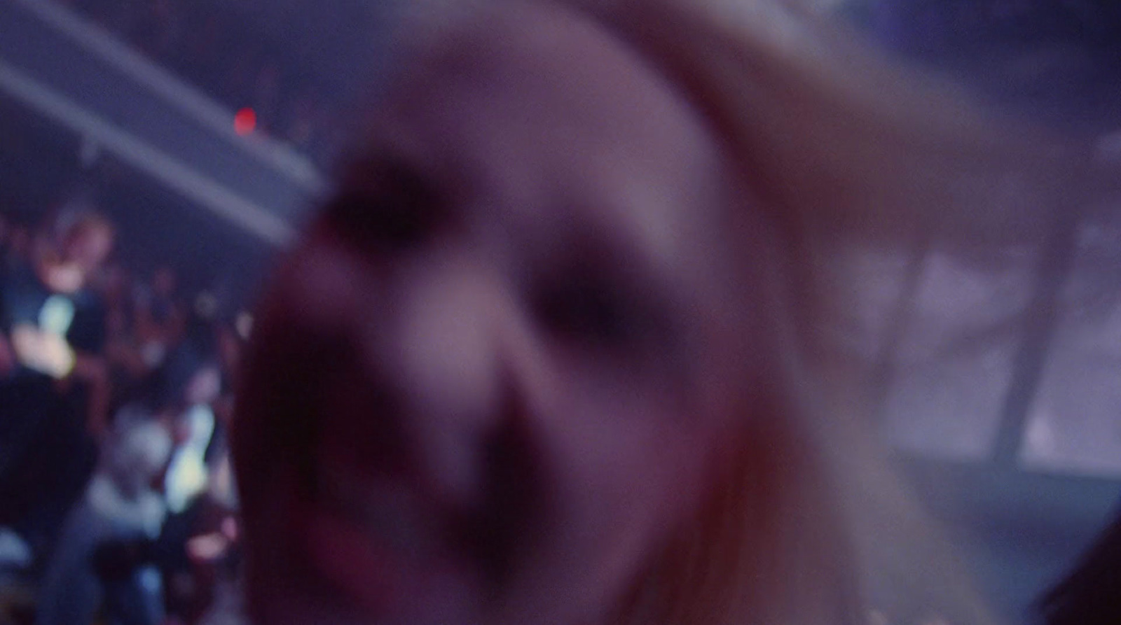 a blurry photo of a person's face at a concert