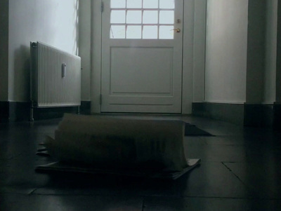 a roll of toilet paper sitting on the floor in front of a door