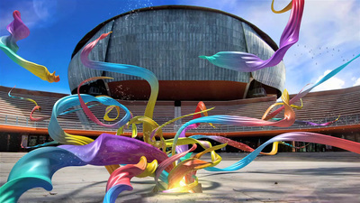 a colorful sculpture in front of a large building