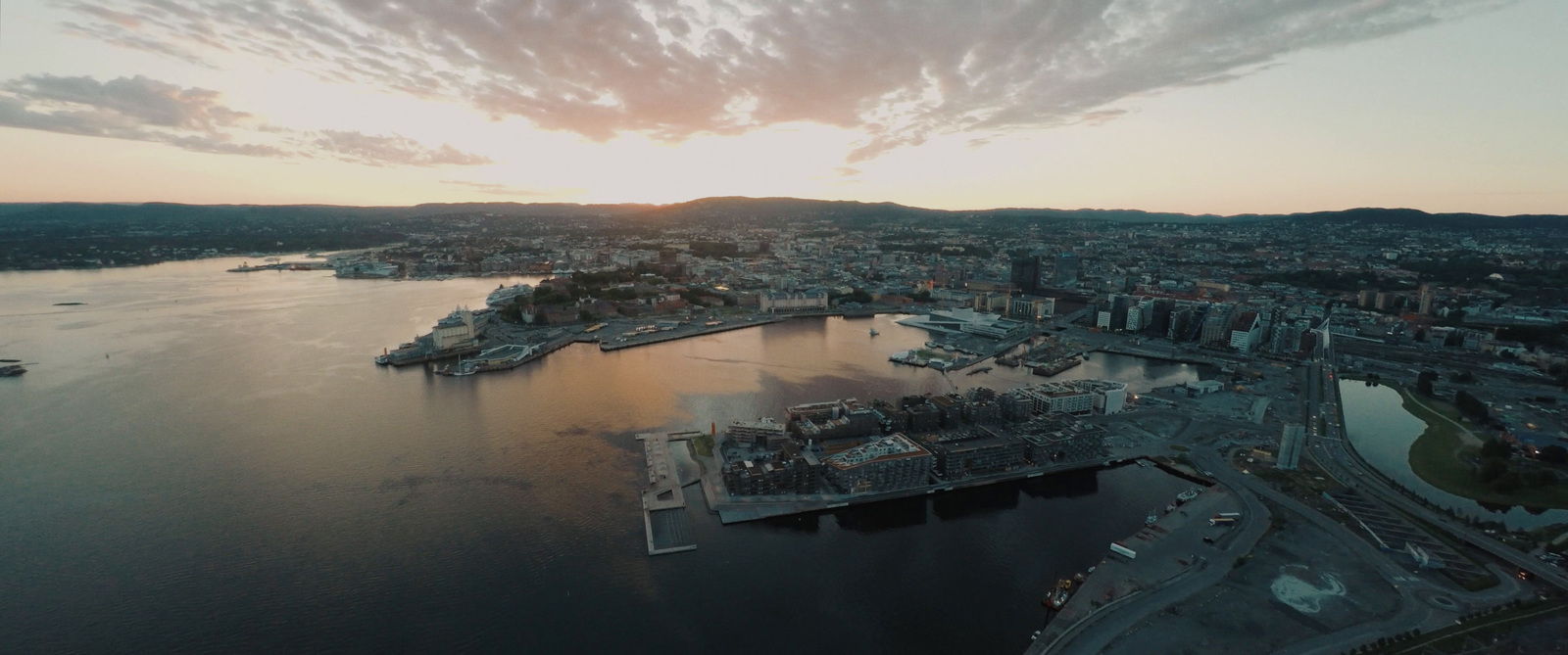 an aerial view of a city at sunset