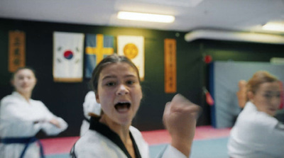 a group of people in a room with karate gear