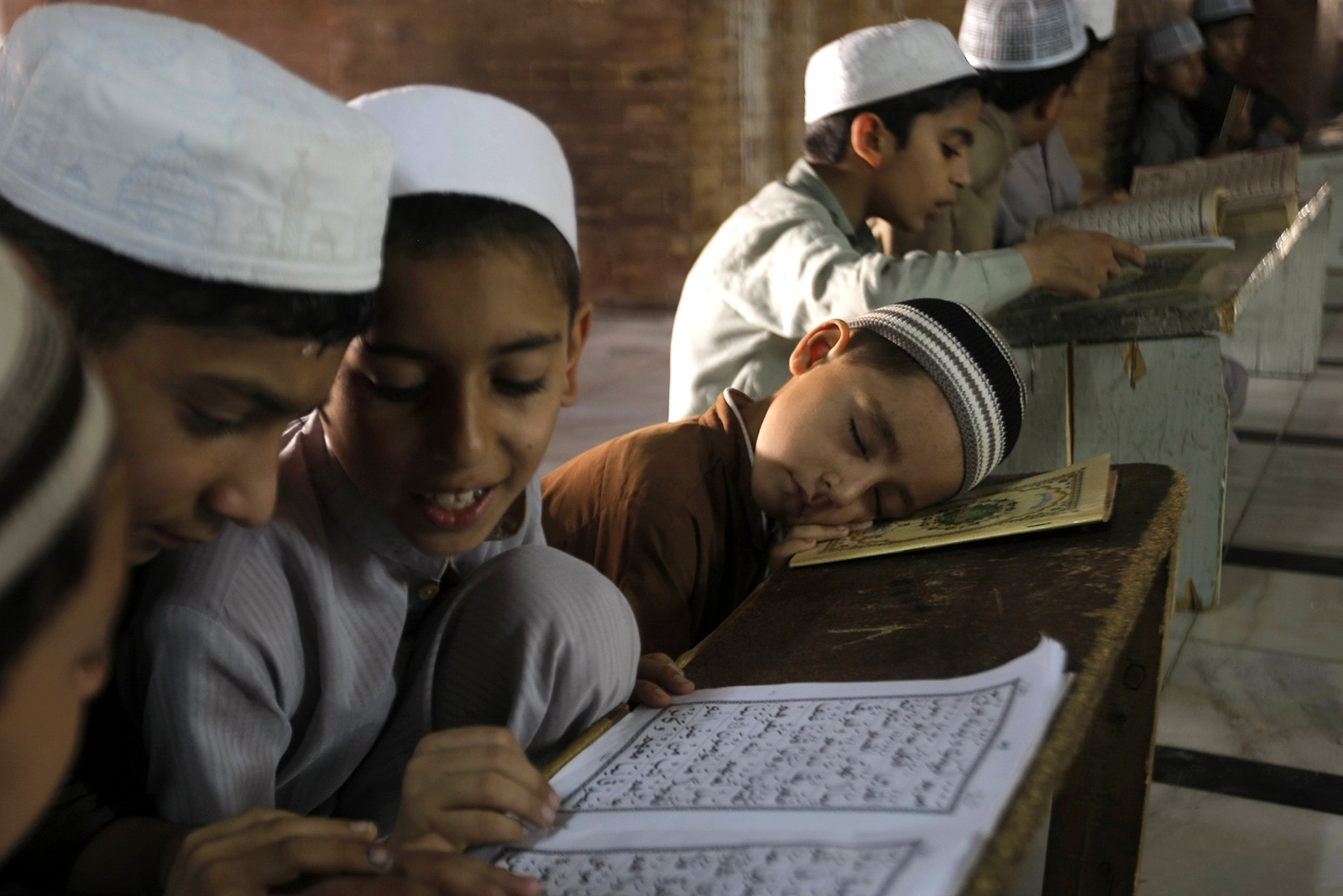 a group of people sitting at a table with a book