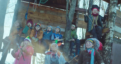 a group of children sitting on top of a tree