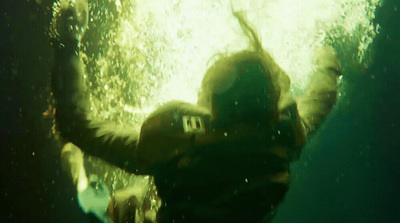 a person in a wet suit under water