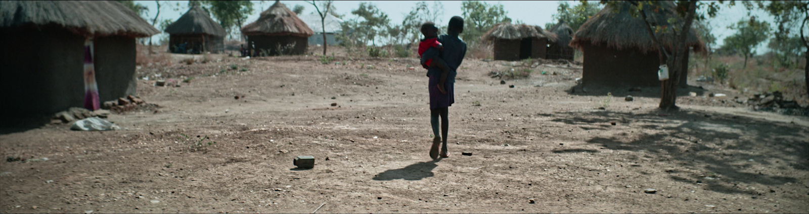 a person standing in the dirt with a stick