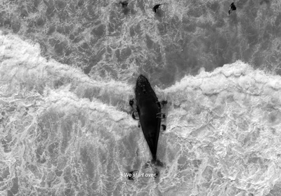 an aerial view of a surfer riding a wave