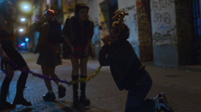 a group of young people standing on a sidewalk