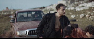 a man walking next to a group of people near a truck