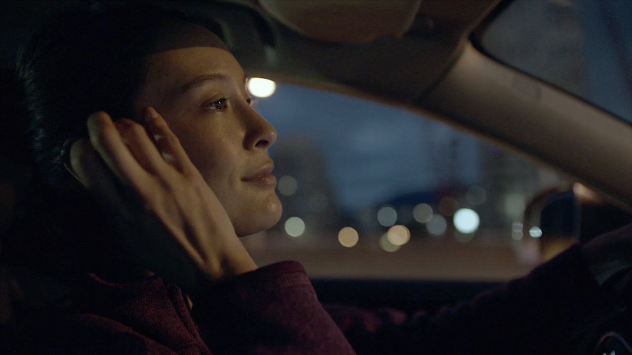 a woman sitting in a car talking on a cell phone