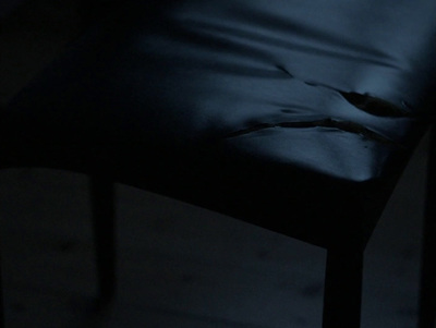 a close up of a chair in a dark room