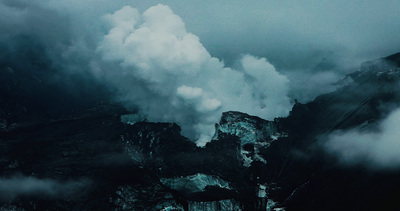 a mountain covered in smoke and steam