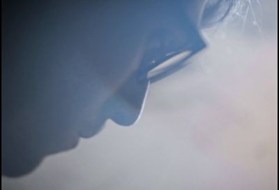 a close up of a person's face with a blurry background