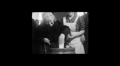 an old photo of two women in a kitchen