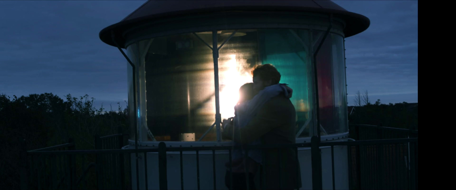 a person standing in front of a light house