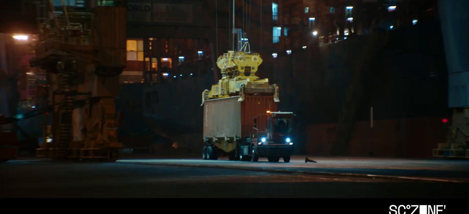 a truck driving down a city street at night