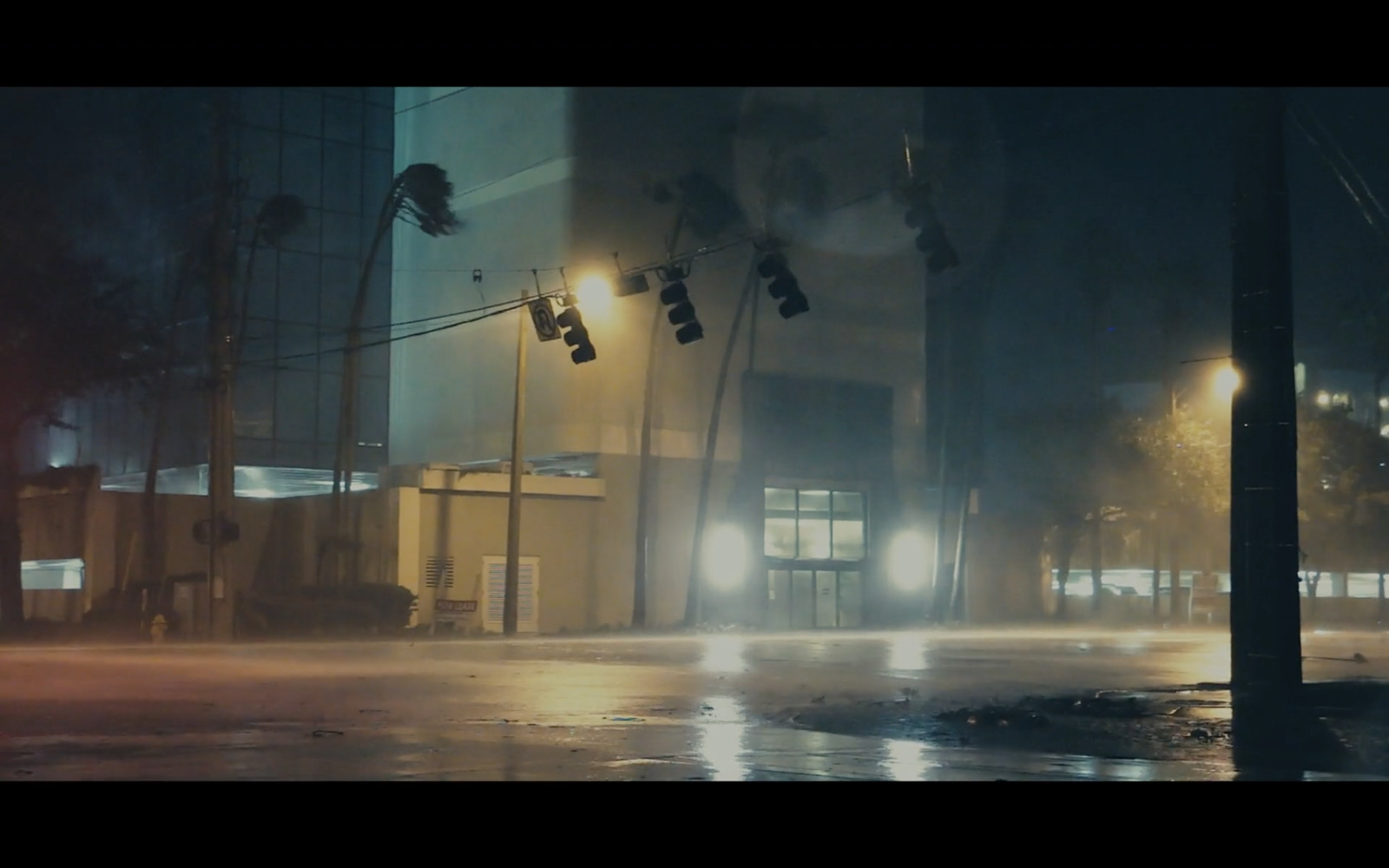 a city street at night with rain and street lights