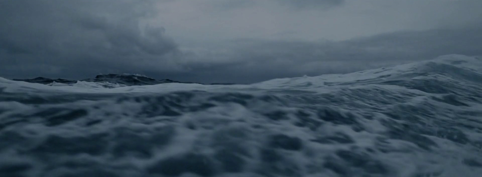 a large body of water under a cloudy sky