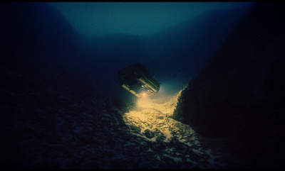 a boat in the water with a light coming out of it