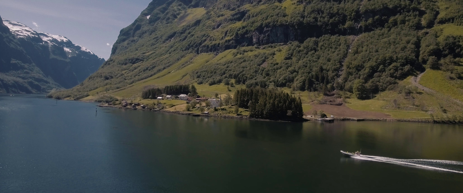 a boat is traveling down a river in a mountainous area