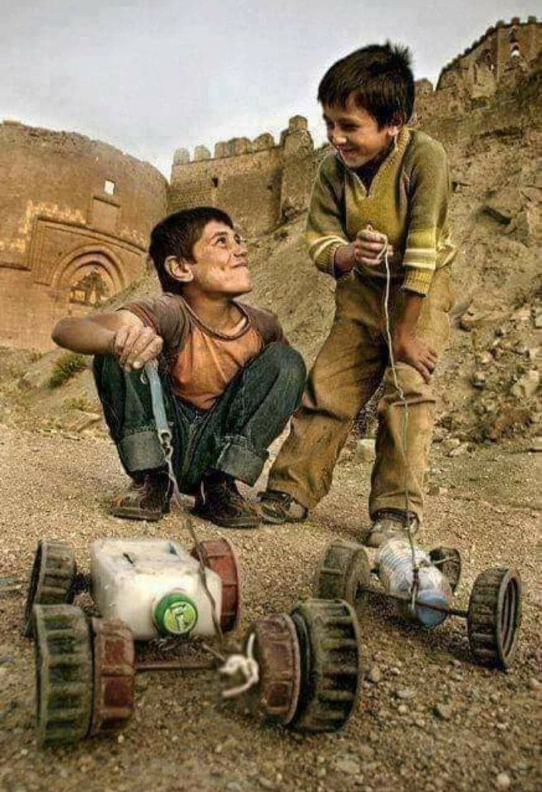 a young boy is playing with a toy car