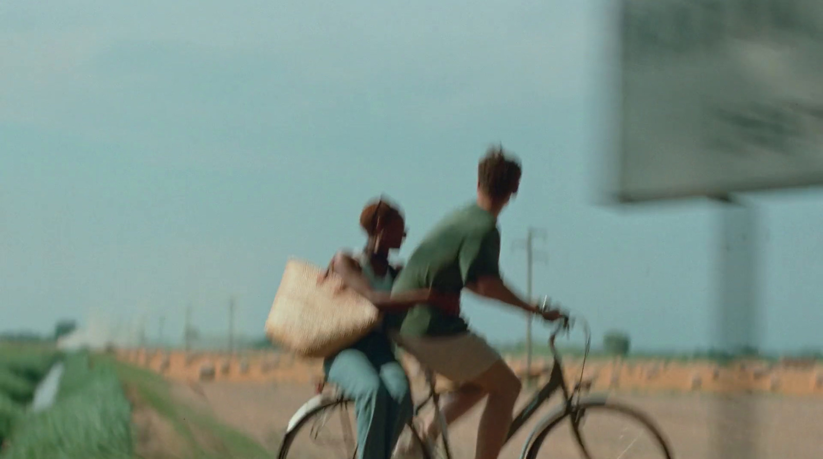 a couple of people riding on the back of a bike