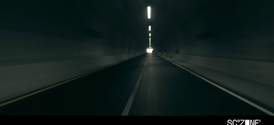 a car driving through a tunnel in the dark