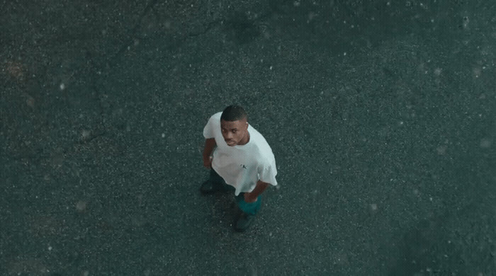 a man in a white shirt and blue pants