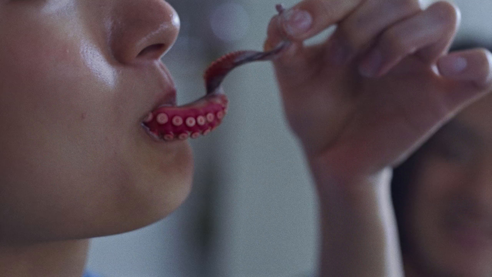 a woman is brushing her teeth with a toothbrush