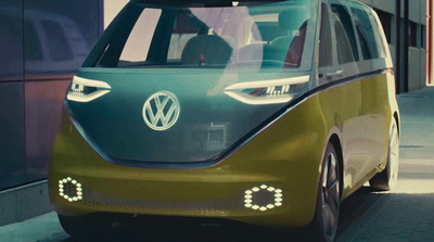 a green and white car parked on the side of a street