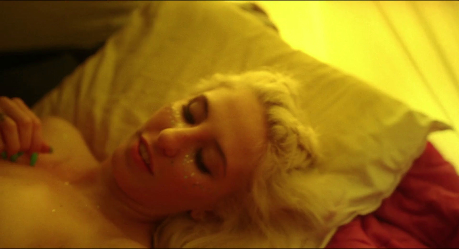 a woman laying on a bed with a white hair