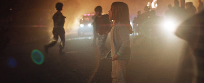 a group of people standing on a road at night