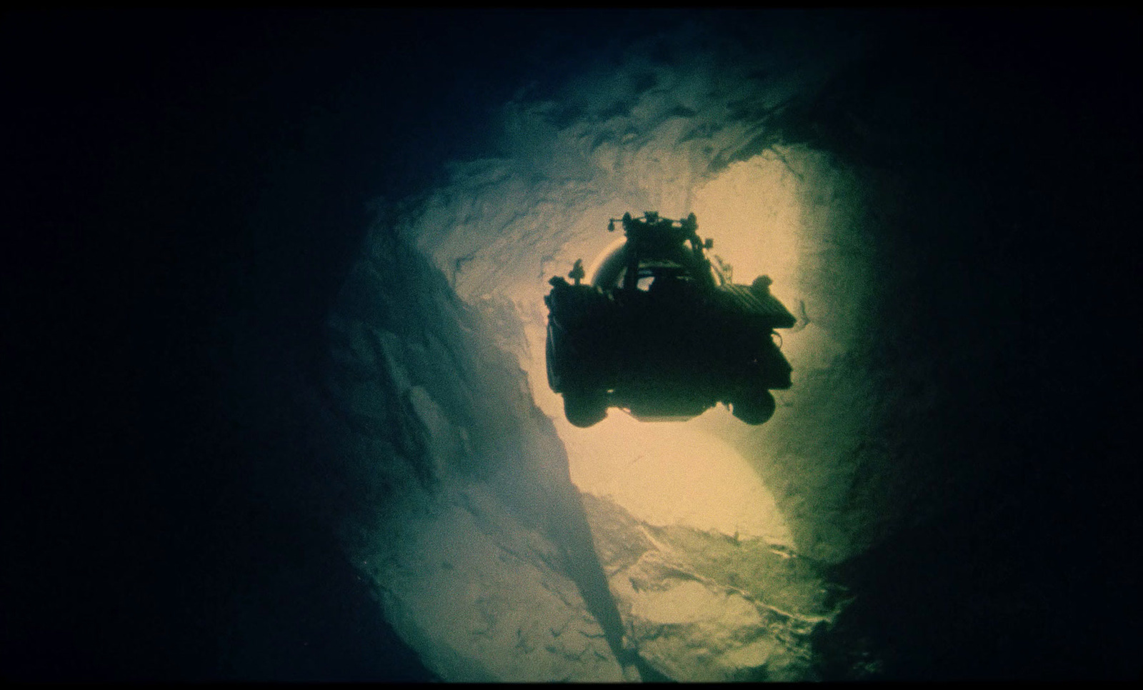 a person riding a vehicle through a cave