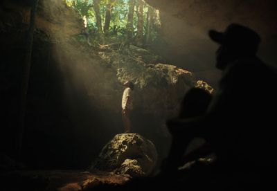 a man standing in the middle of a cave