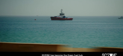 a red boat in the middle of a large body of water