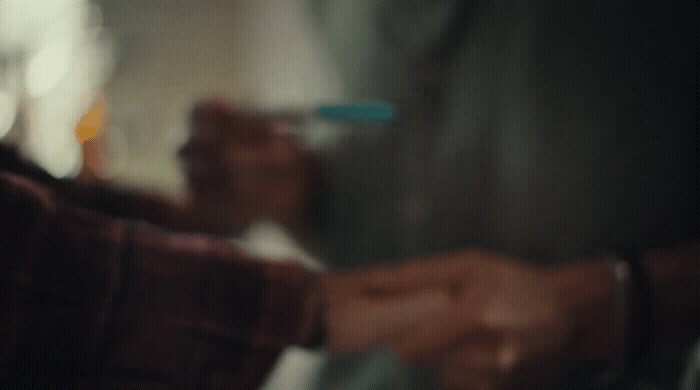 a blurry image of a person holding a toothbrush